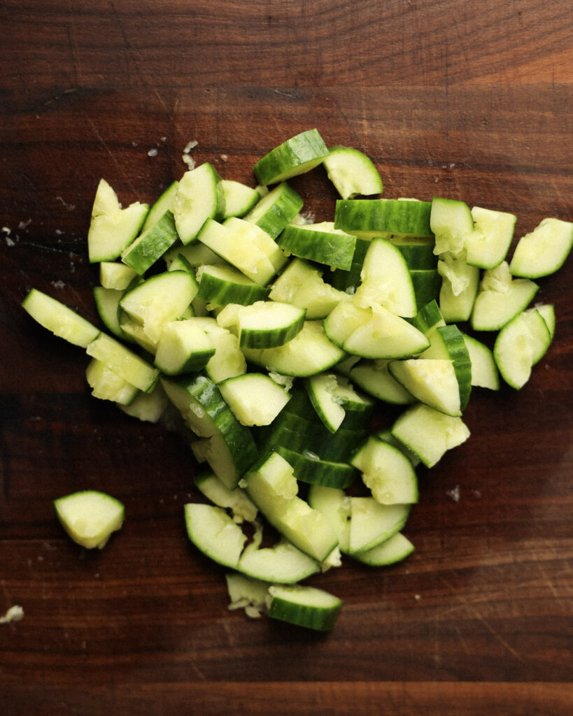smashed cucumber on a cutting board.