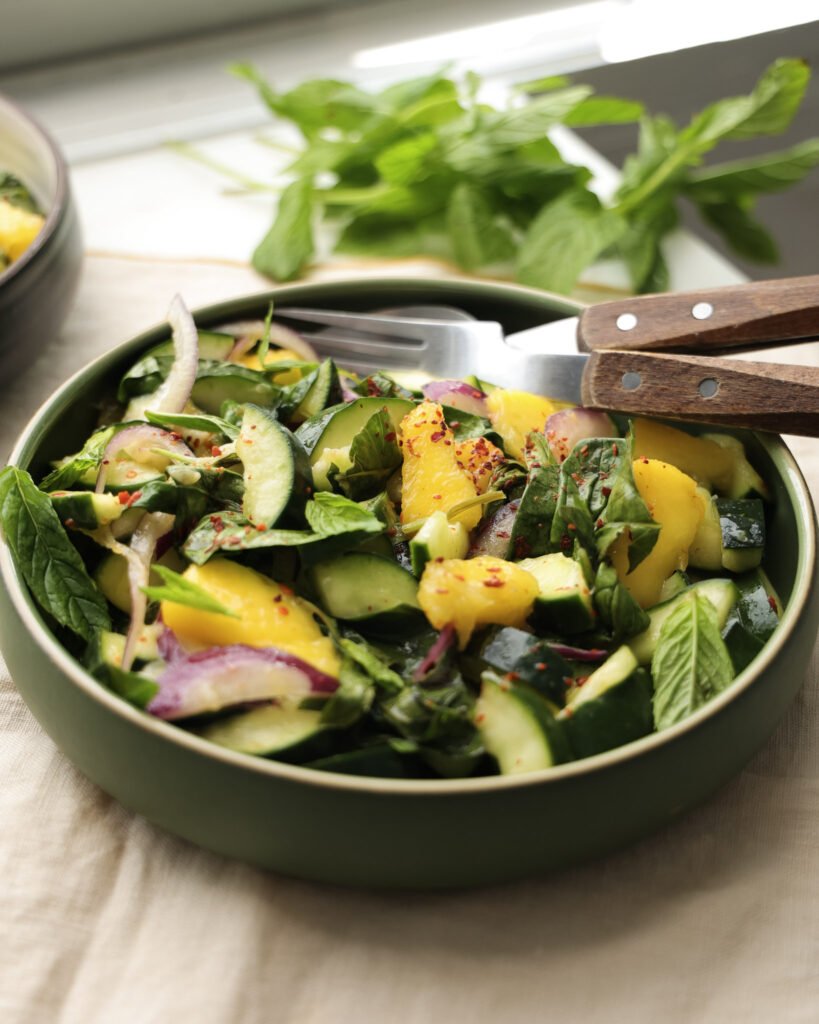 Cucumber and mango salad in a bowl.